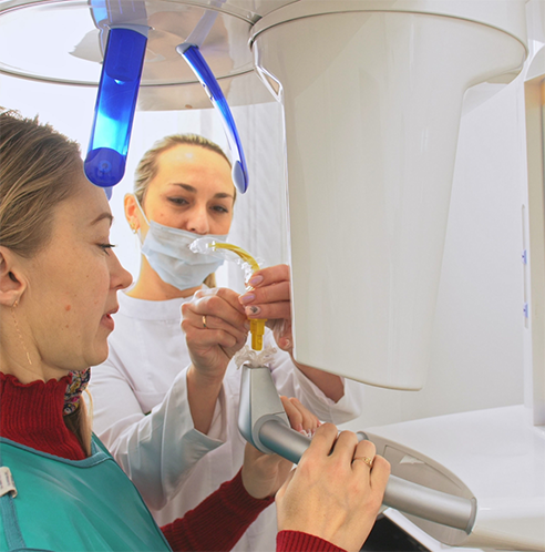 Patient about to have teeth scanned with cone beam scanner