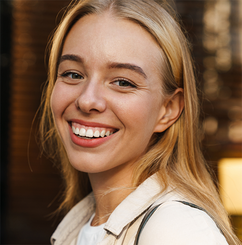 Blonde woman smiling and showing gums