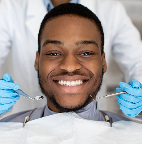 Man sitting in dental chair smiling