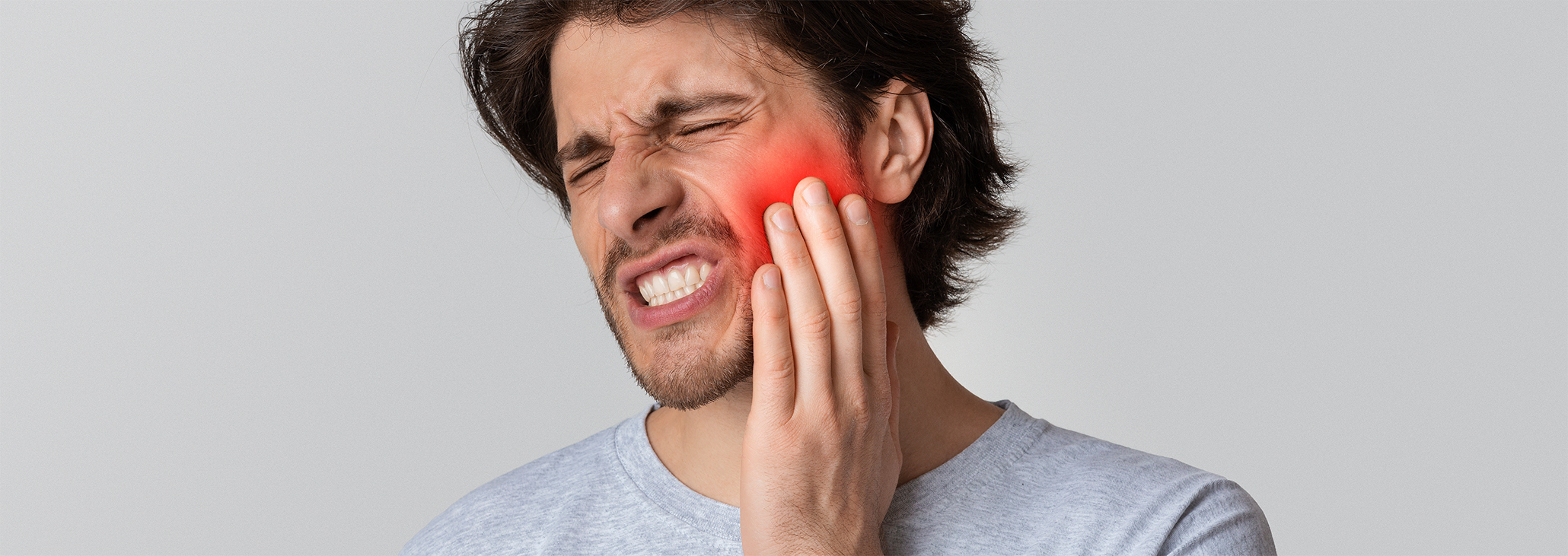 Close up of man rubbing his jaw