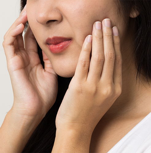 Close up of woman rubbing jaw