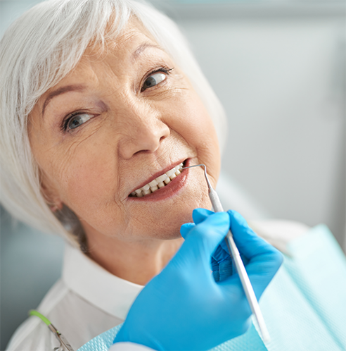Senior woman having teeth checked by dentist