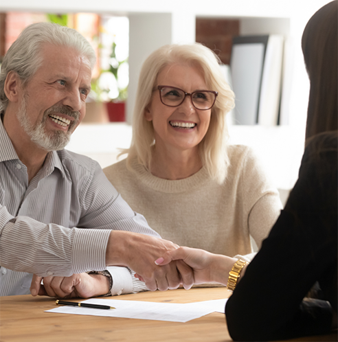 Man and woman speaking to dentist at desk