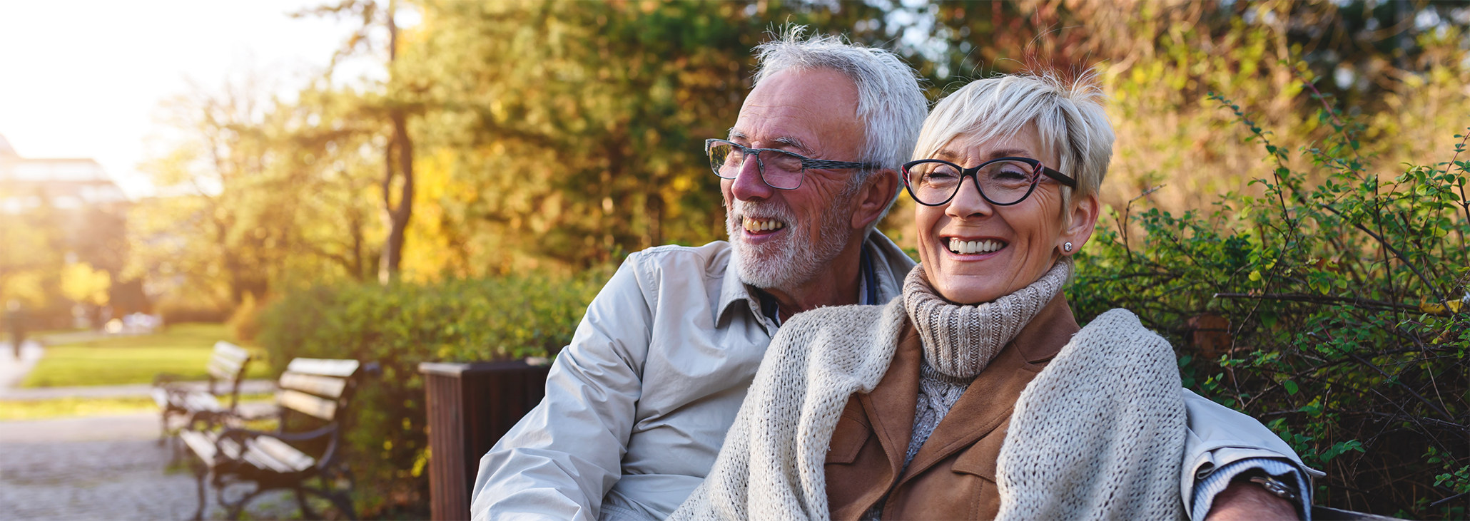 Older man and woman sitting outside