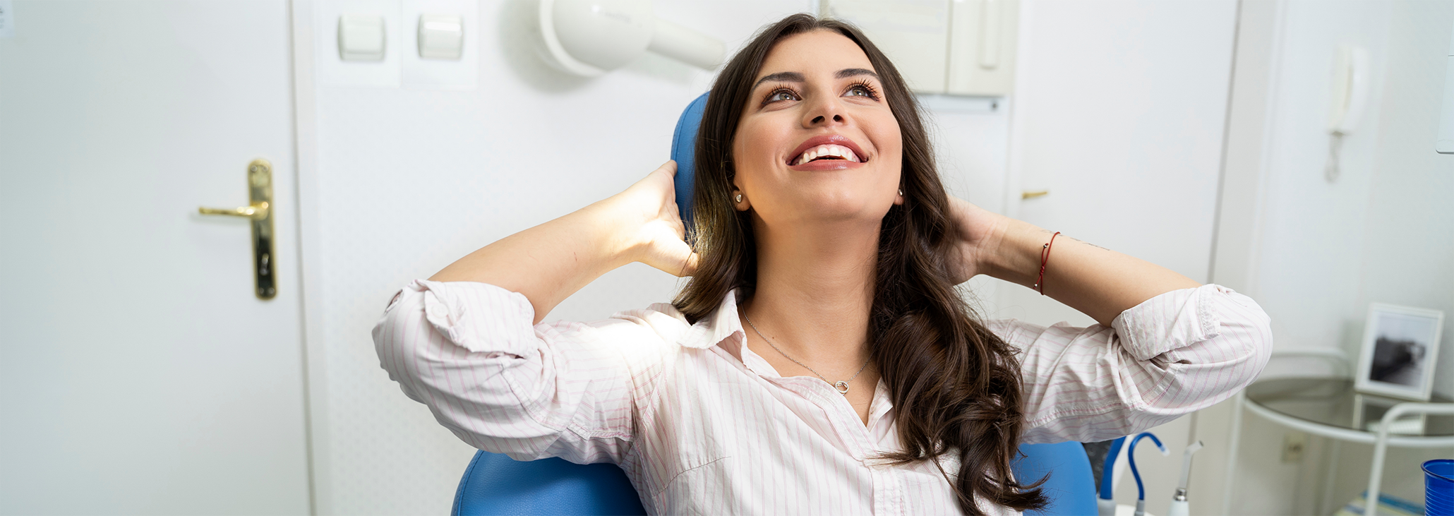 Woman smiling and relaxing in dental chair