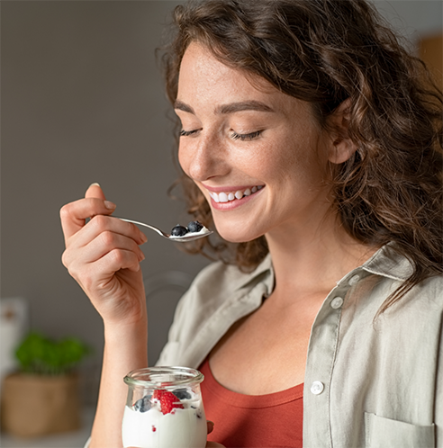 Woman eating yogurt with fruit