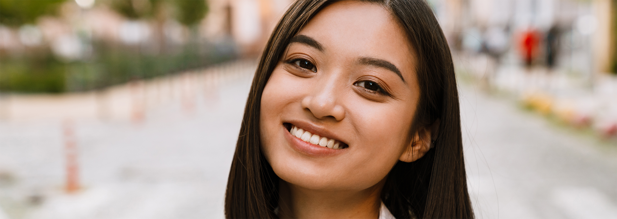 Woman walking down street smiling