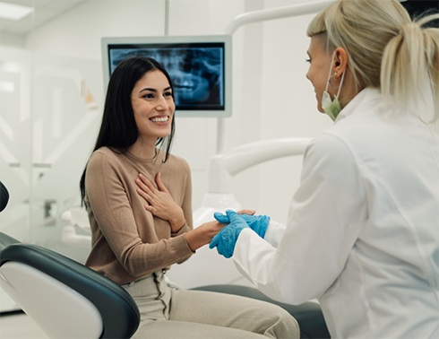 Female patient shaking dentist's hand